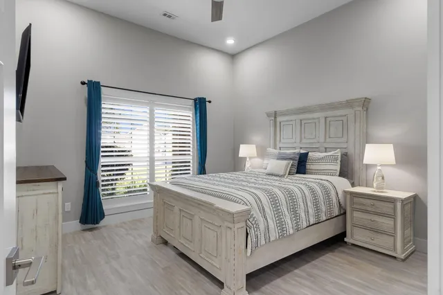 a bedroom with a bed and a large window