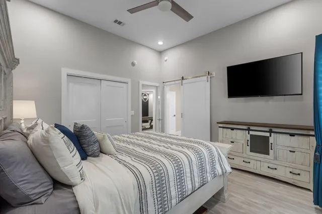 a bedroom with a bed and a flat screen tv