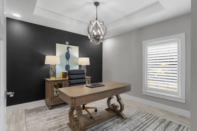 a view of a workspace with furniture and a window