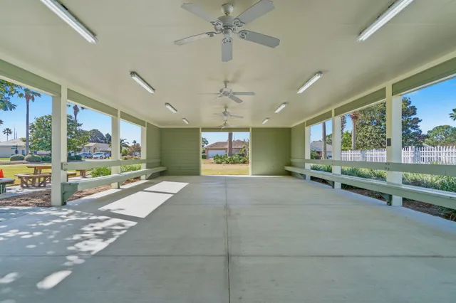 a view of a house with swimming pool and sitting area