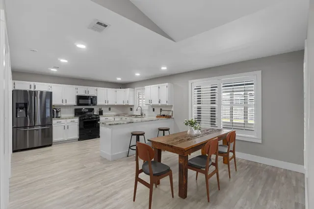 a kitchen with a table and chairs in it