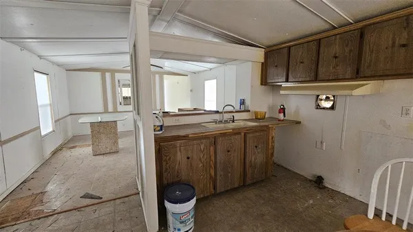 a kitchen with sink cabinets and stove
