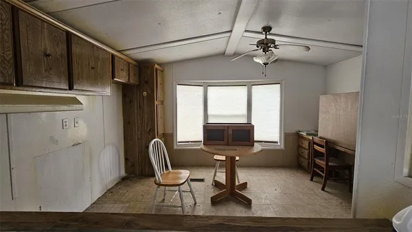 a workspace with wooden floor and windows