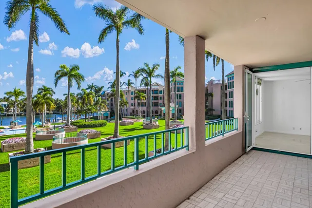 a view of a house with a yard and potted plants