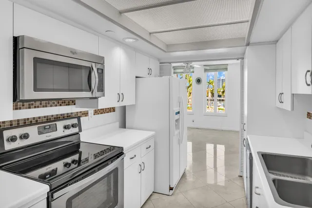 a kitchen with a sink stove and refrigerator