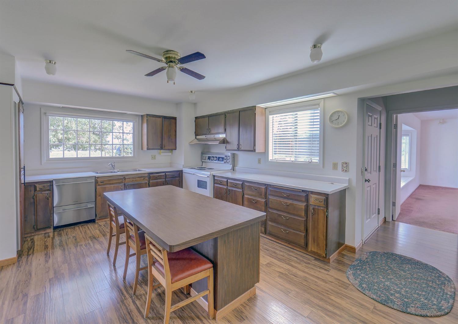 3710 Calhoun Road Medford, OR 97501 - Photo 9 of 18 a kitchen with wooden floors and wooden cabinets