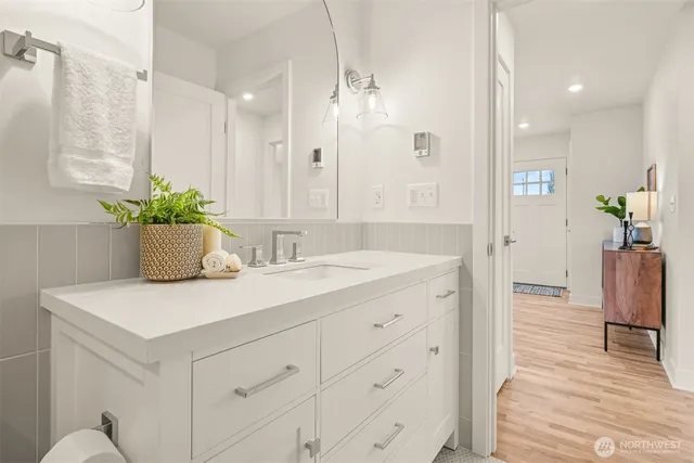 a bathroom with a sink a mirror and a shower
