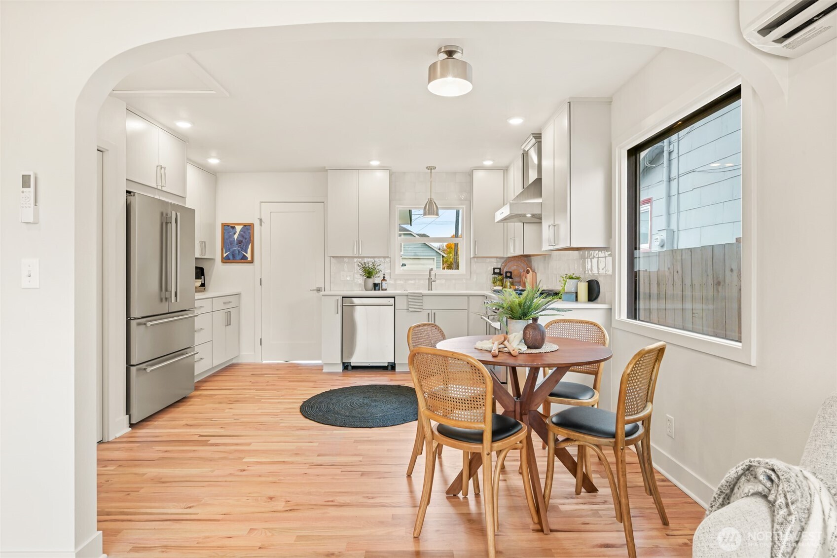 2111 Franklin Street Bellingham, WA 98225 - Photo 18 of 39 a kitchen with stainless steel appliances kitchen island granite countertop a dining table chairs and a refrigerator