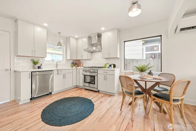 a kitchen with a table chairs sink and cabinets