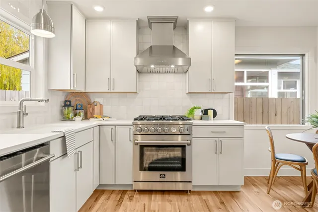 a kitchen with white cabinets and white appliances