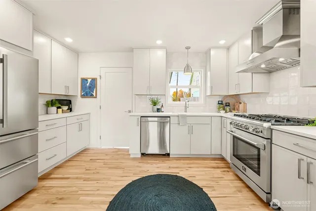 a kitchen with white cabinets and white appliances