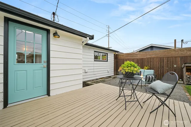 a view of a patio with table and chairs and wooden floor