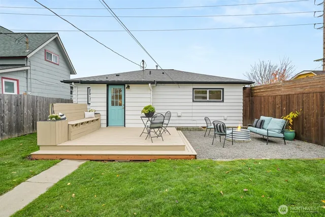 a view of a patio with table and chairs with wooden fence