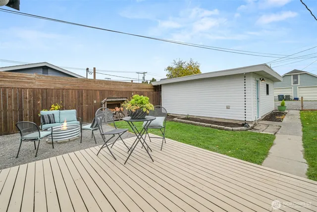 a view of a chairs and table on the wooden deck
