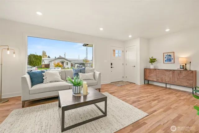 a living room with furniture and a potted plant