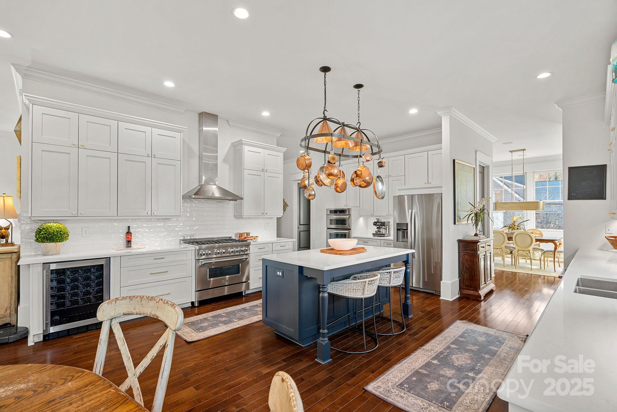 206 Meadowbrook Road Charlotte, NC 28211 - Photo 11 of 48 a kitchen with stainless steel appliances granite countertop a stove top oven a sink dishwasher and white cabinets with wooden floor