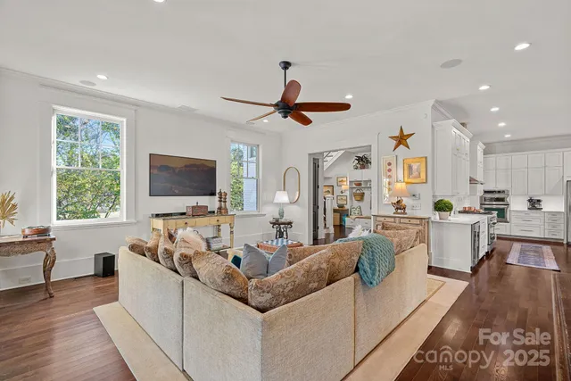 a living room with furniture flat screen tv and window