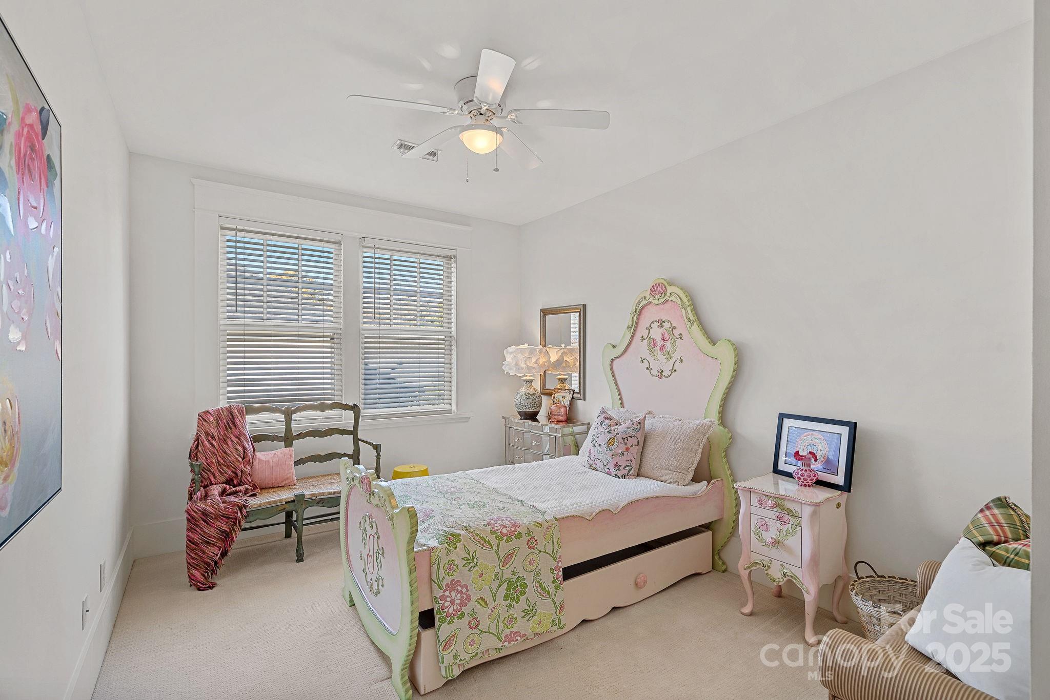 206 Meadowbrook Road Charlotte, NC 28211 - Photo 26 of 48 a bedroom with a bed and a chandelier