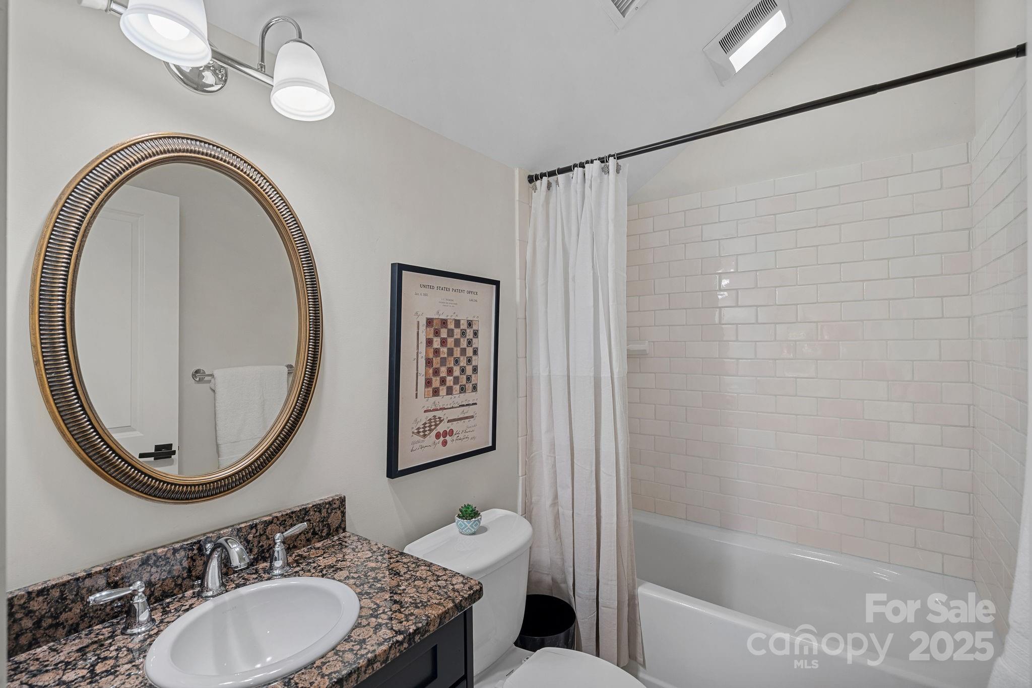 206 Meadowbrook Road Charlotte, NC 28211 - Photo 34 of 48 a bathroom with a granite countertop sink a mirror and a shower