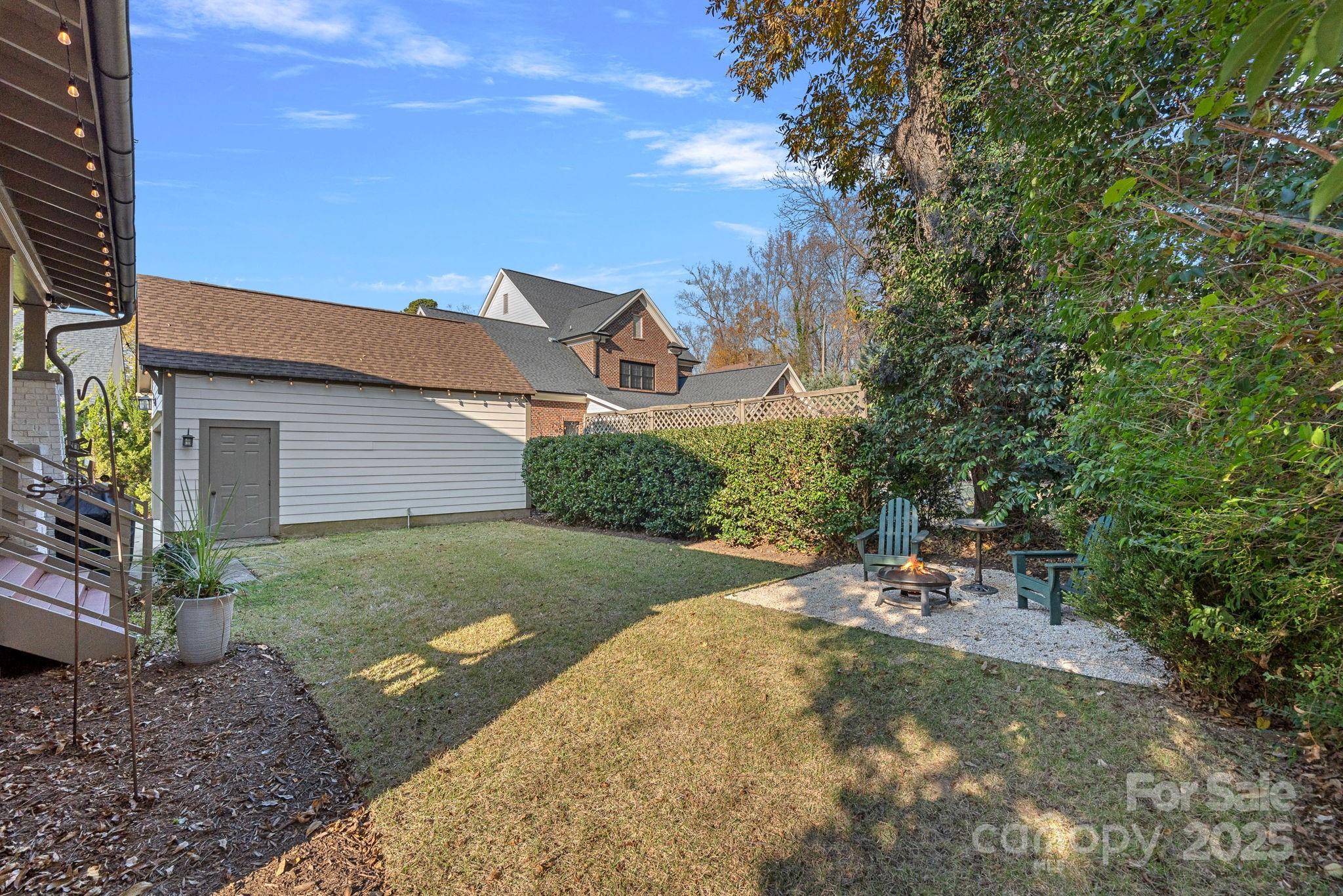 206 Meadowbrook Road Charlotte, NC 28211 - Photo 40 of 48 a view of a patio with table and chairs under an umbrella