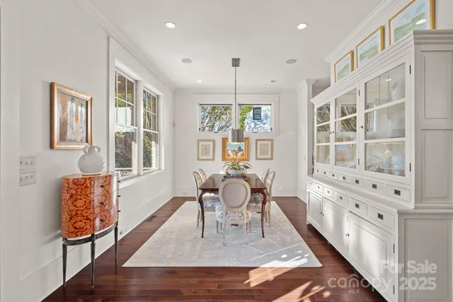 a living room with furniture windows and wooden floor
