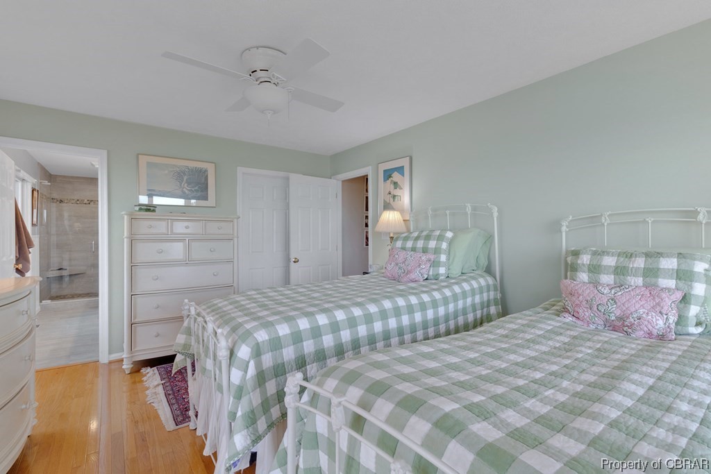 362 Beach Creek Road Lancaster, VA 22503 - Photo 20 of 47 Bedroom with connected bathroom, a closet, light wood-type flooring, and ceiling fan