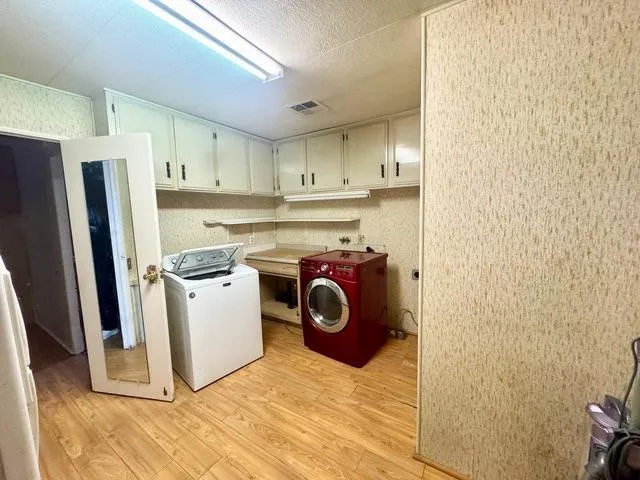 a kitchen with stainless steel appliances granite countertop a refrigerator a stove and a sink