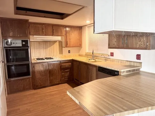 a kitchen with a sink a stove and a refrigerator