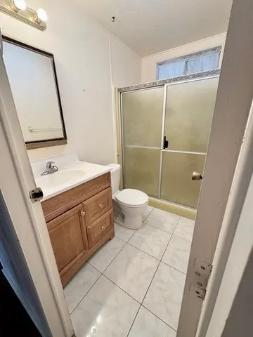 a bathroom with a sink a toilet a mirror and vanity
