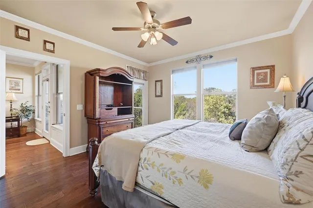 a bedroom with a large bed and a chandelier