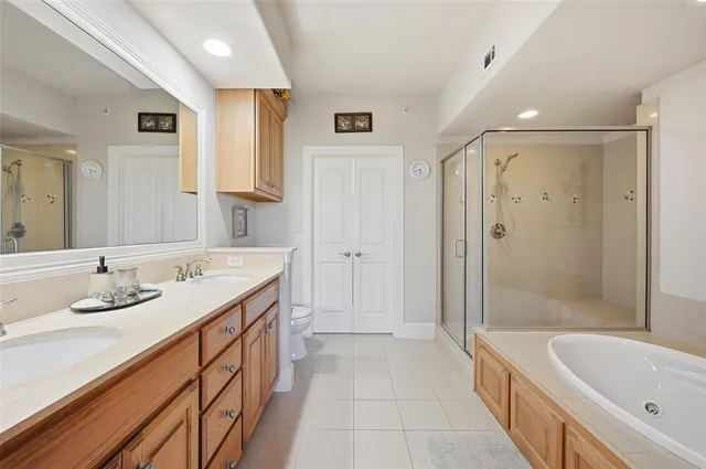 a bathroom with a tub sink and mirror