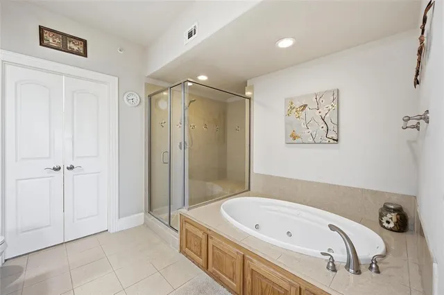 a spacious bathroom with a tub sink and mirror