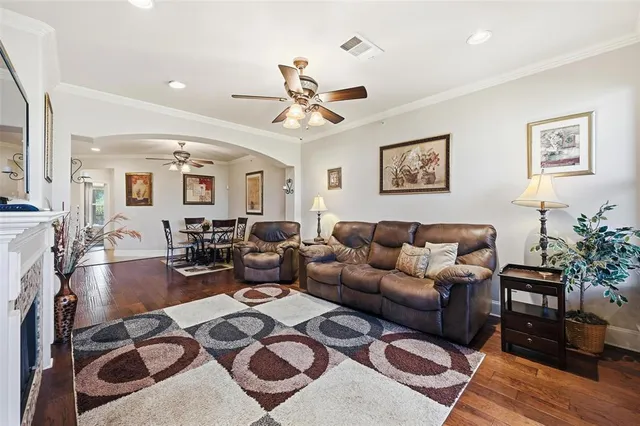 a living room with furniture a chandelier and a dining table