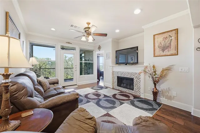 a living room with furniture fireplace and a large window