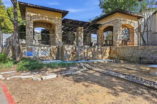a front view of a house with a yard and potted plants