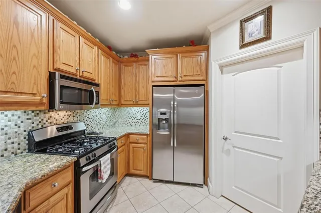 a kitchen with granite countertop cabinets and window