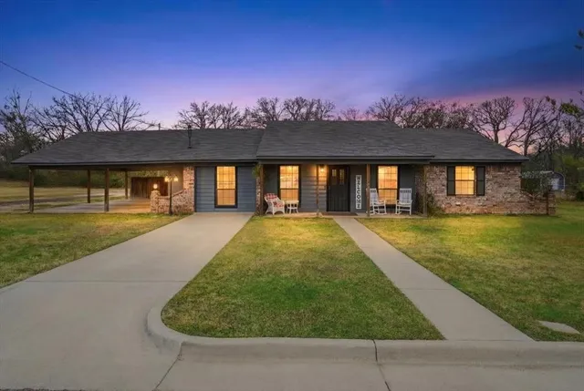 a view of swimming pool with a yard and a large tree