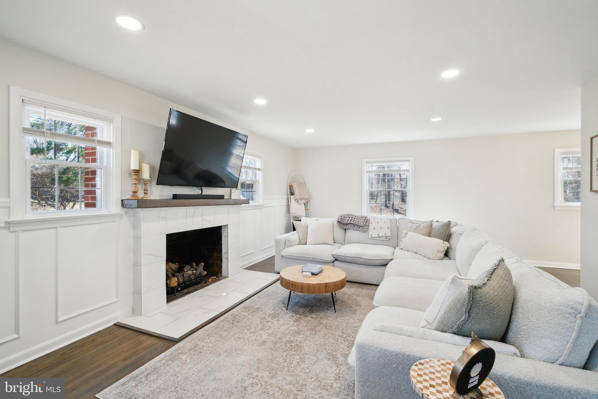 306 Cowpath Road Lansdale, PA 19446 - Photo 7 of 30 a living room with furniture a flat screen tv and a fireplace