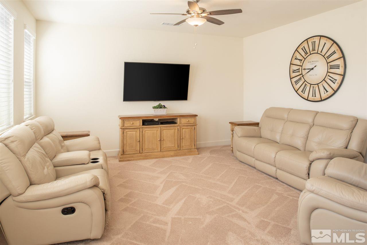 10120 Culiacan Pass Trail Reno, NV 89521 - Photo 8 of 33 a living room with furniture and a flat screen tv