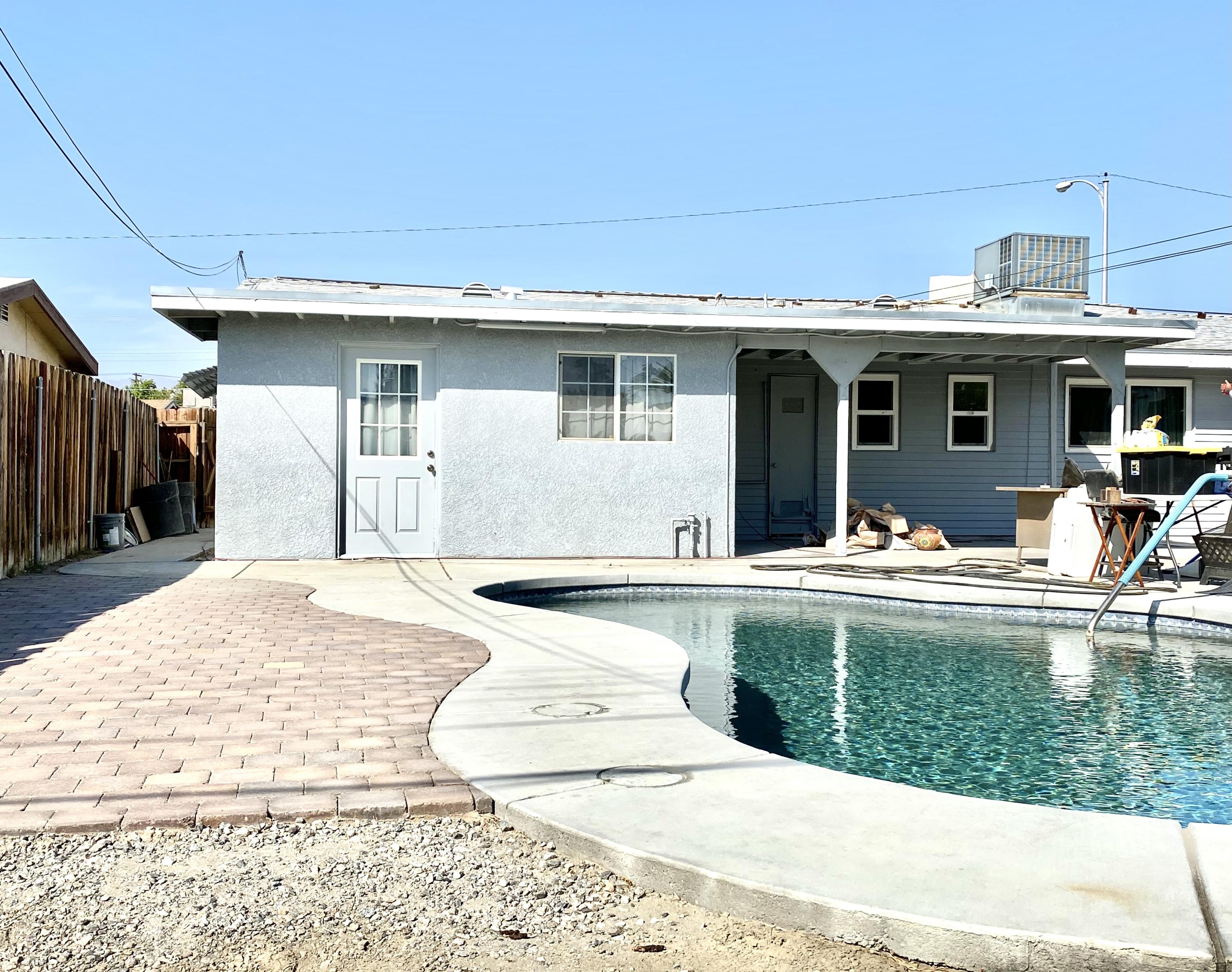 82407 Adobe Road Indio, CA 92201 - Photo 3 of 3 a view of a house with pool porch and furniture