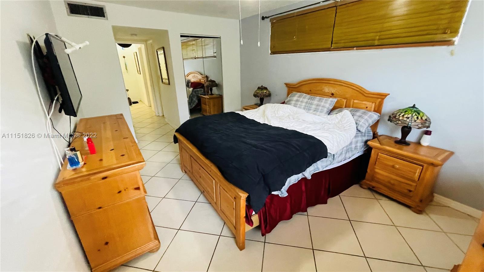 Second Forum Condominium North Miami Beach, FL 33179 - Photo 11 of 12 a bedroom with a bed and wooden floor