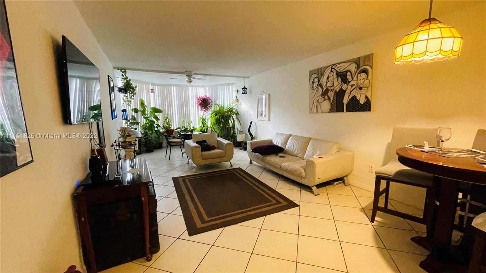 Second Forum Condominium North Miami Beach, FL 33179 - Photo 7 of 12 a living room with furniture and a potted plant