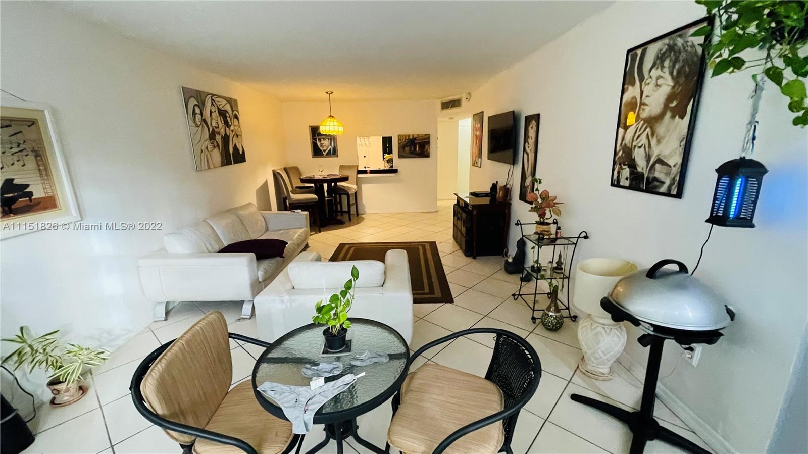 Second Forum Condominium North Miami Beach, FL 33179 - Photo 8 of 12 a living room with furniture and a mirror