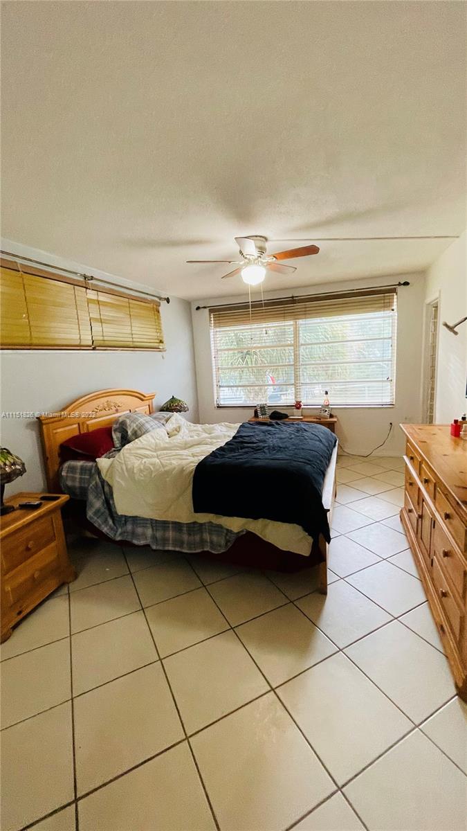 Second Forum Condominium North Miami Beach, FL 33179 - Photo 9 of 12 a bedroom with a bed and a window