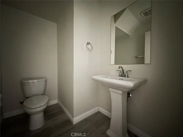 a bathroom with sink toilet and a mirror