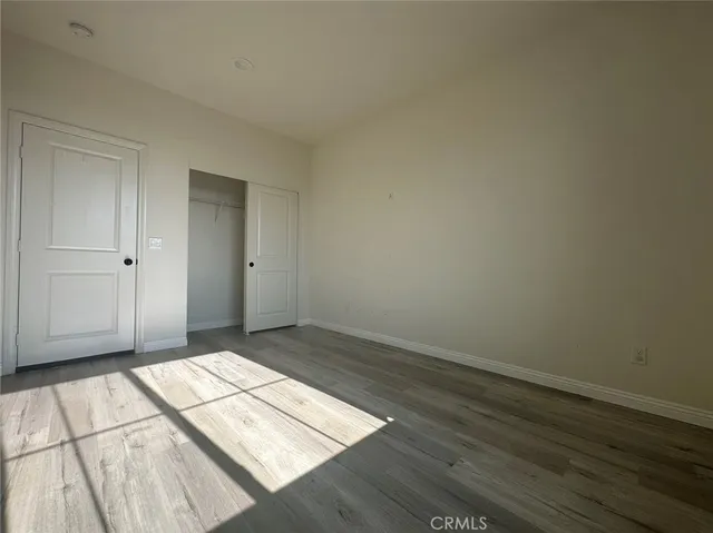 a view of an empty room and wooden floor