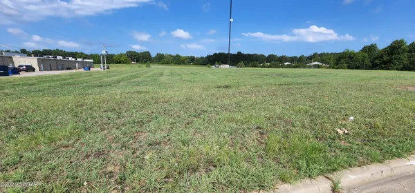a view of a green field with clear sky