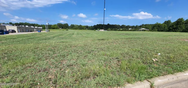 a view of a green field with clear sky