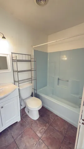 a bathroom with a sink a toilet and bathtub