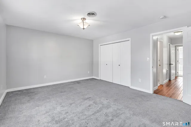a view of an empty room with a chandelier